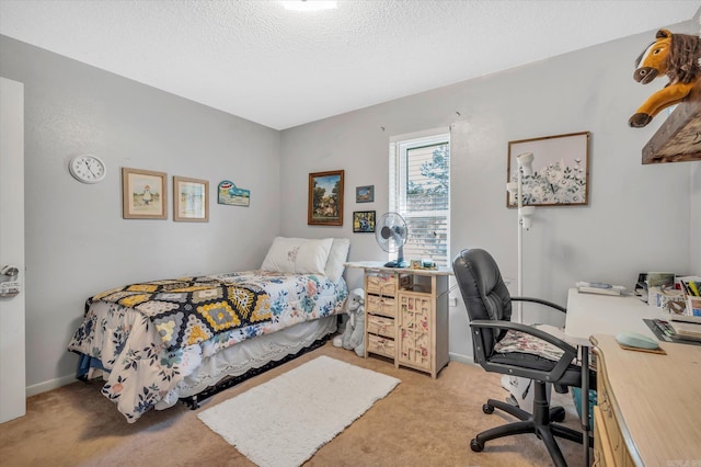 bedroom featuring light colored carpet and a textured ceiling