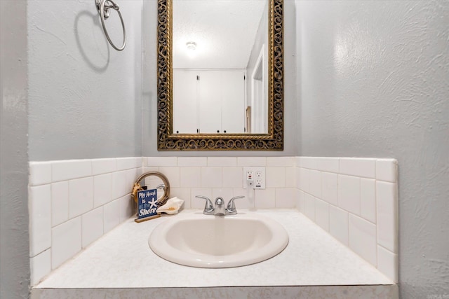 bathroom with vanity and a textured ceiling