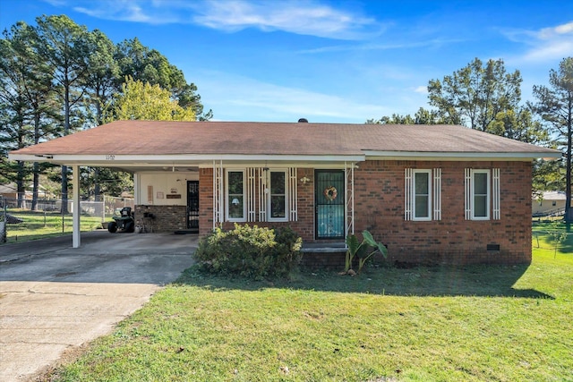 view of front of home with a front yard and a carport