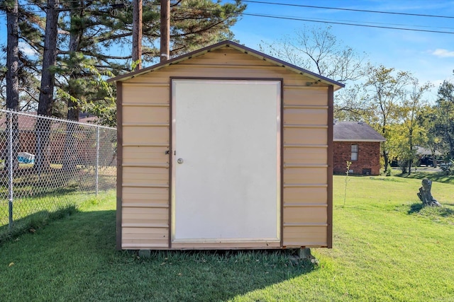 view of outdoor structure featuring a lawn