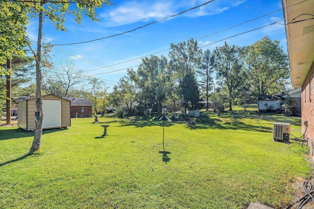 view of yard with central AC and a shed