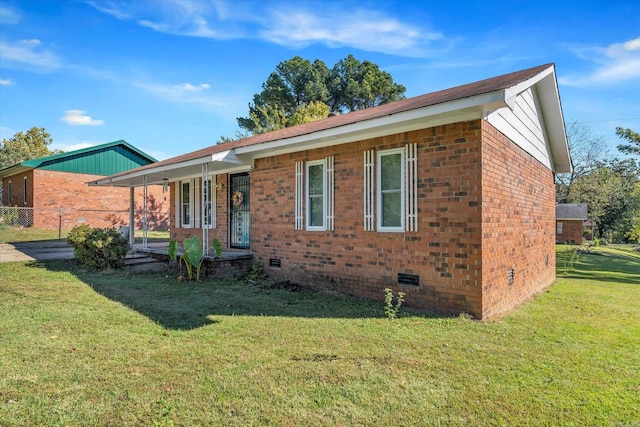 ranch-style house with a porch and a front lawn