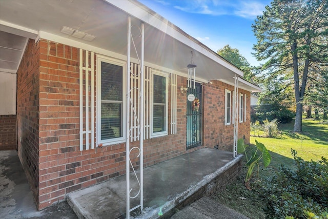 view of exterior entry with a porch