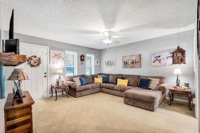 carpeted living room with ceiling fan and a textured ceiling