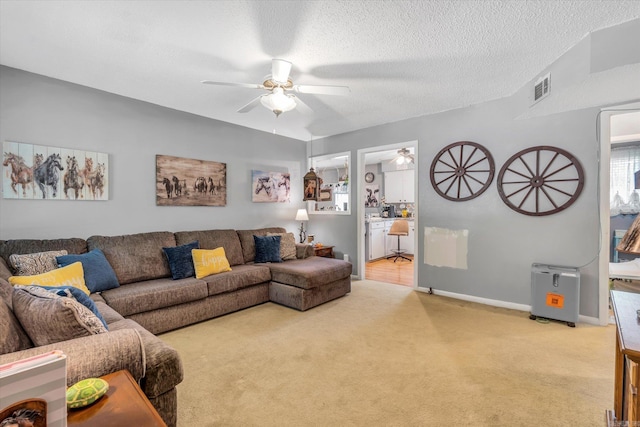 carpeted living room with a textured ceiling and ceiling fan