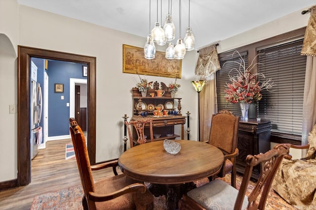 dining room with an inviting chandelier and light hardwood / wood-style flooring