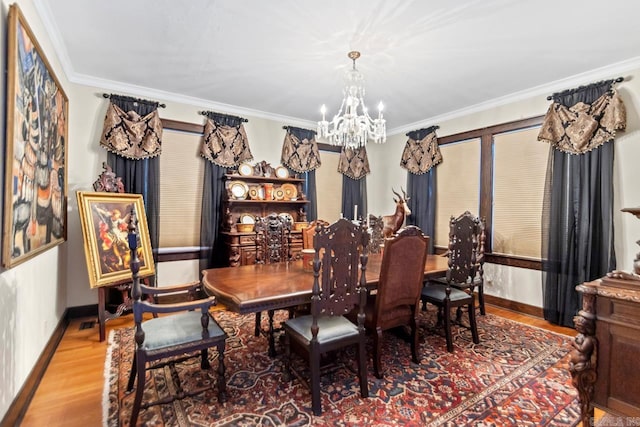 dining area featuring crown molding, hardwood / wood-style floors, and a notable chandelier