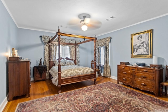 bedroom with hardwood / wood-style flooring, ceiling fan, and ornamental molding