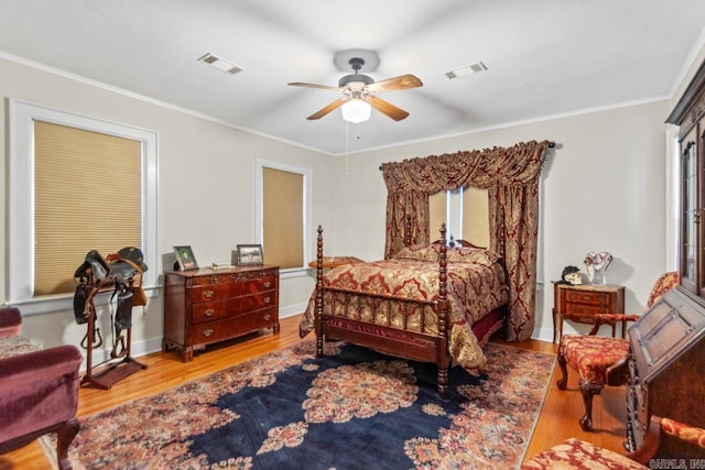 bedroom with ceiling fan, light hardwood / wood-style floors, and ornamental molding