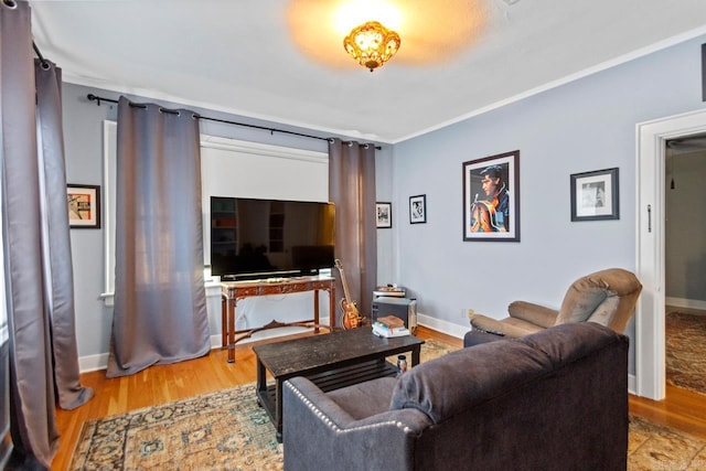 living room featuring light wood-type flooring and ornamental molding