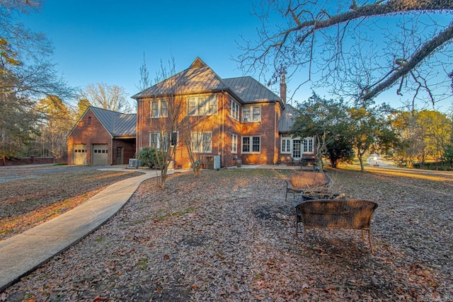 view of front of property with a garage and central AC unit