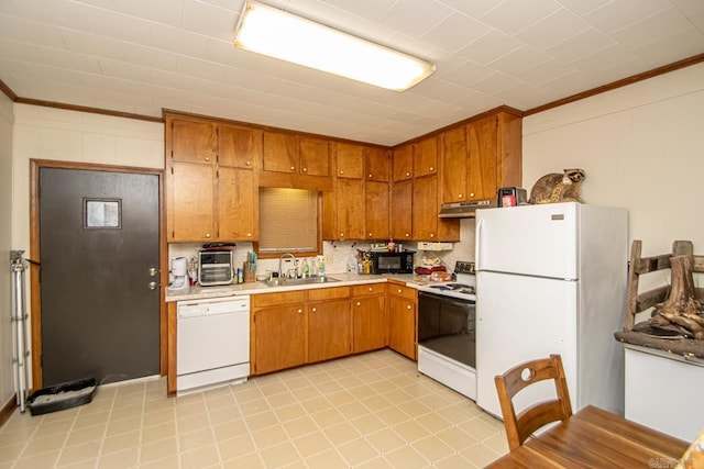 kitchen featuring white appliances, crown molding, and sink