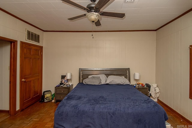 bedroom featuring ceiling fan, dark parquet flooring, and ornamental molding