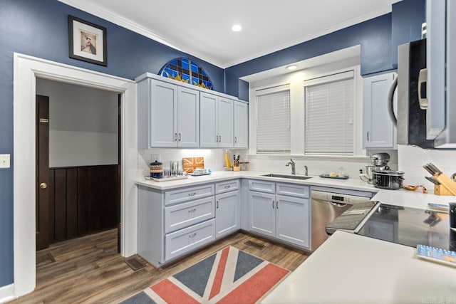 kitchen featuring dishwasher, sink, dark hardwood / wood-style floors, backsplash, and ornamental molding