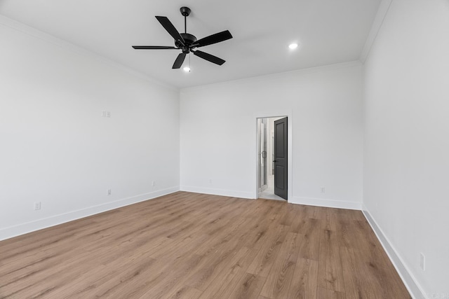 spare room with crown molding, light hardwood / wood-style flooring, and ceiling fan