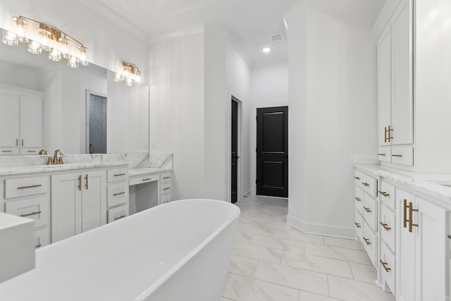 bathroom featuring vanity, a tub to relax in, and ornamental molding