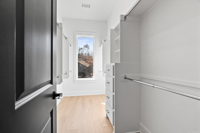 spacious closet featuring light hardwood / wood-style flooring