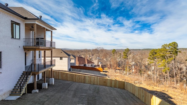 view of yard with a balcony