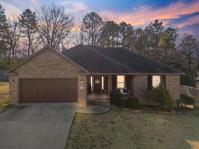 single story home with a lawn and a garage