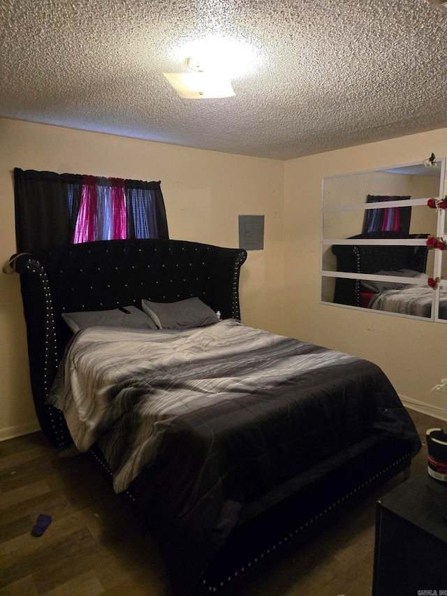 bedroom featuring hardwood / wood-style floors and a textured ceiling