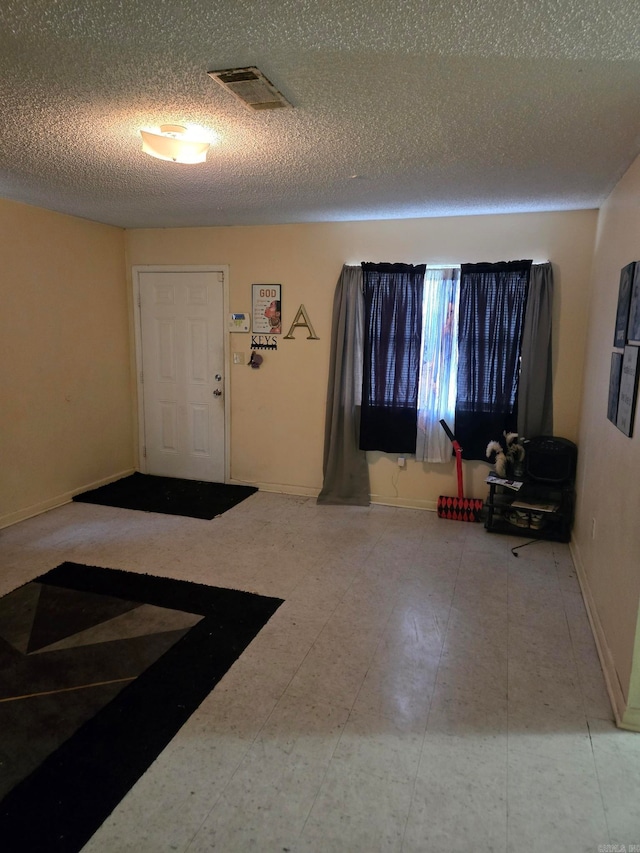 foyer with a textured ceiling