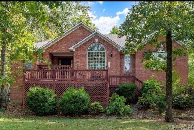 back of property with a lawn and a wooden deck