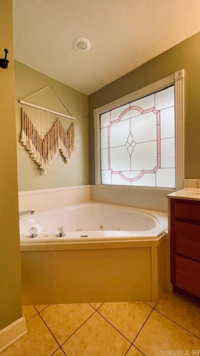 bathroom featuring tile patterned floors, vanity, and a bathing tub