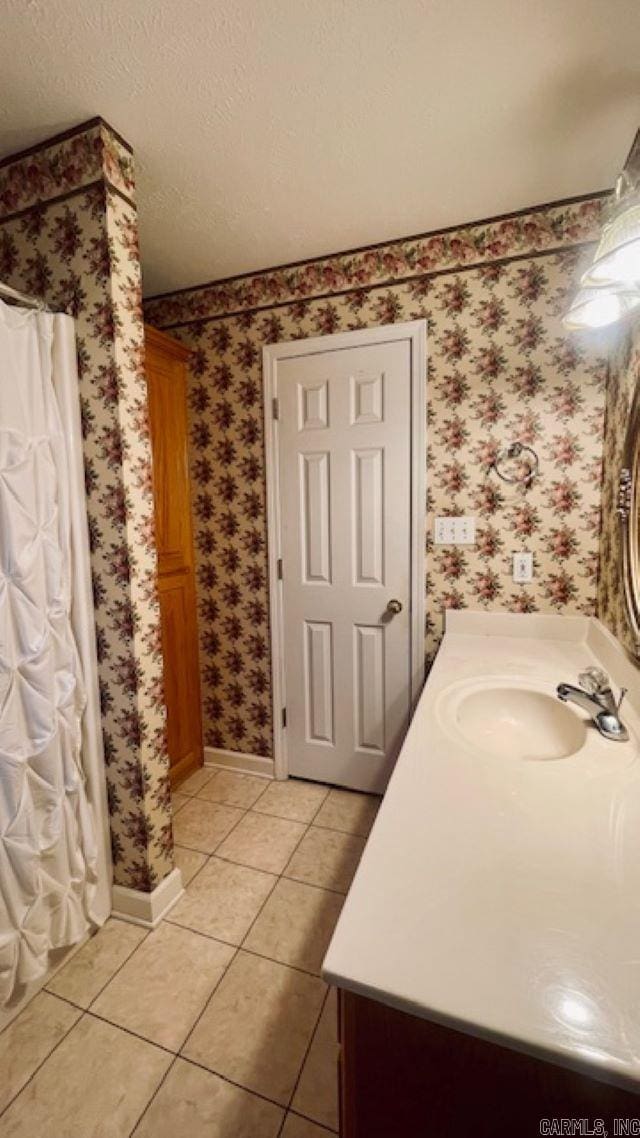 bathroom featuring tile patterned floors, vanity, a shower with curtain, and a textured ceiling