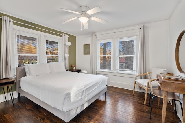 bedroom featuring ceiling fan, dark hardwood / wood-style flooring, and crown molding