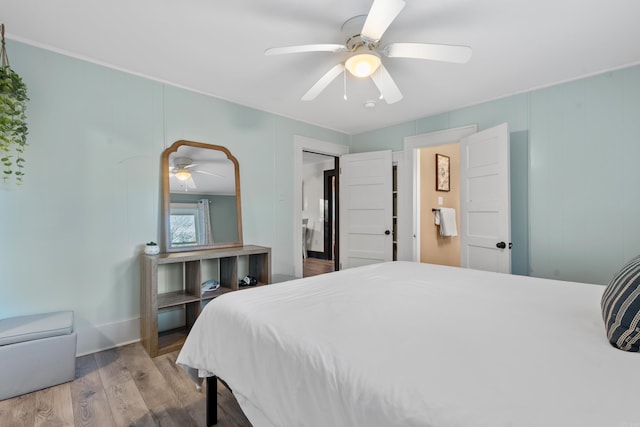 bedroom with light hardwood / wood-style floors and ceiling fan