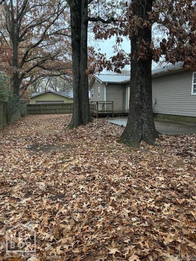 view of yard with a patio and a wooden deck