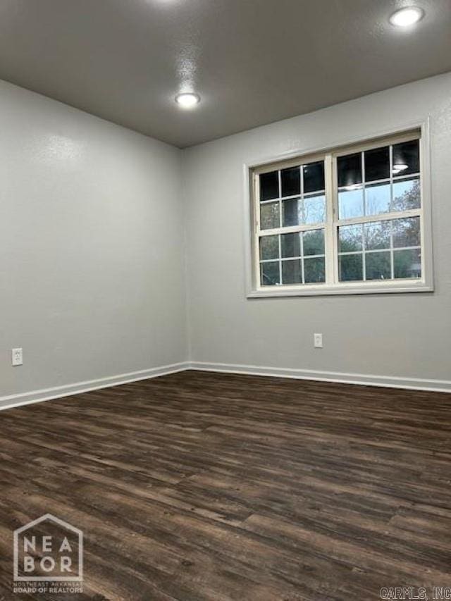 unfurnished room with dark hardwood / wood-style floors