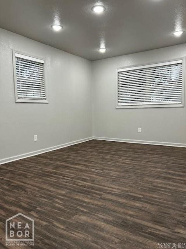 unfurnished room featuring dark wood-type flooring