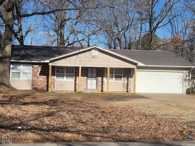 ranch-style house with covered porch and a garage