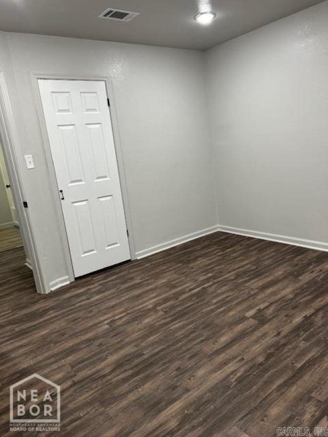 spare room featuring dark hardwood / wood-style floors