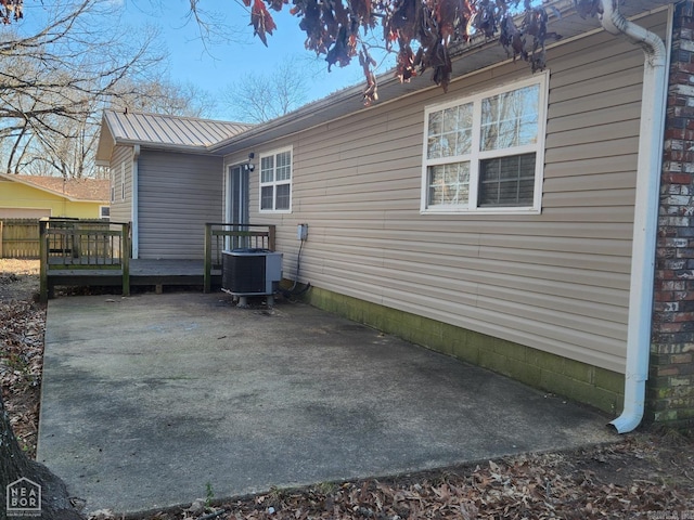 back of house with central AC and a deck