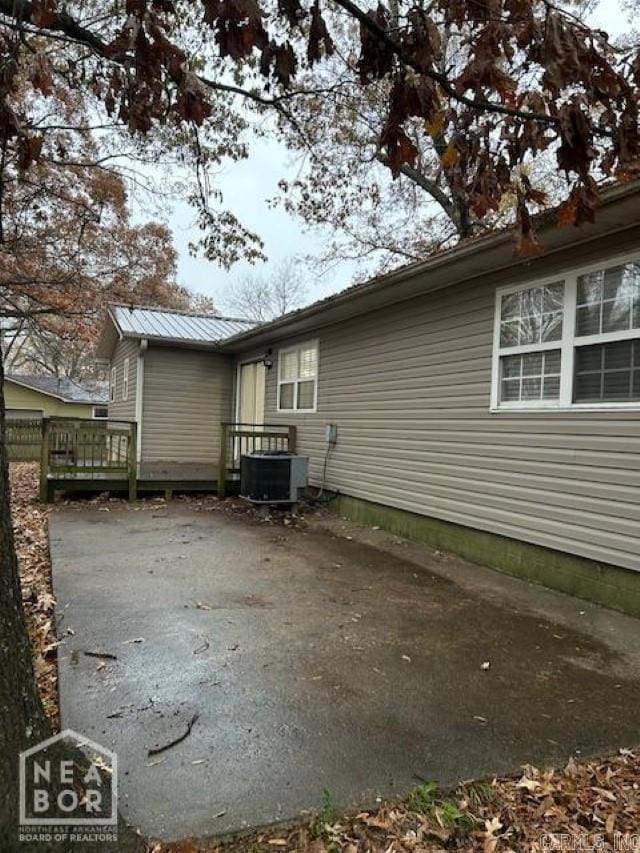 view of home's exterior featuring central AC and a wooden deck