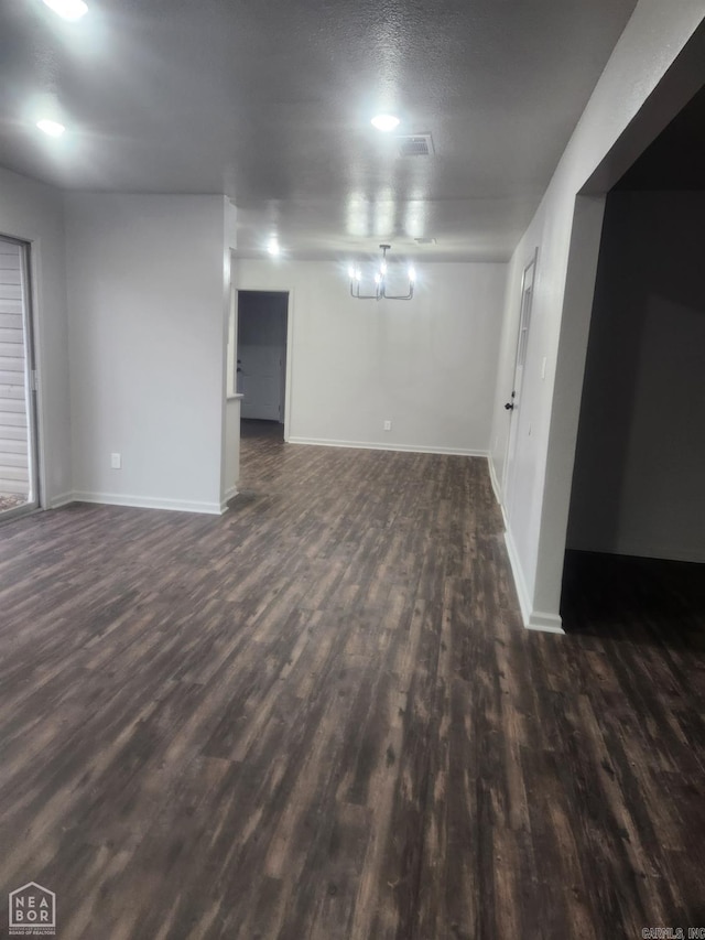 basement featuring a textured ceiling and dark wood-type flooring