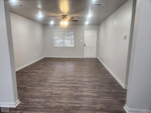 unfurnished room featuring dark hardwood / wood-style floors and ceiling fan