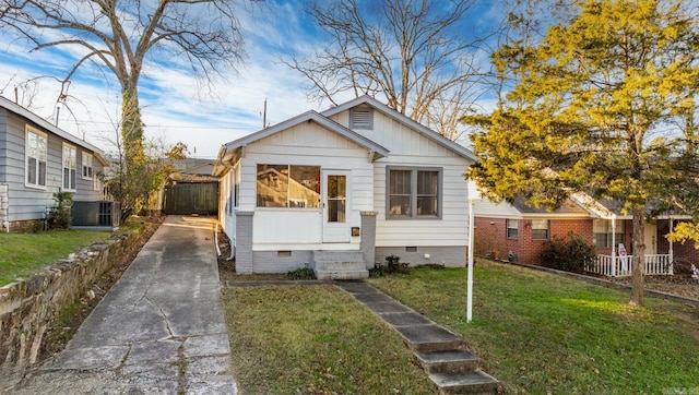 bungalow-style home with central AC unit and a front yard