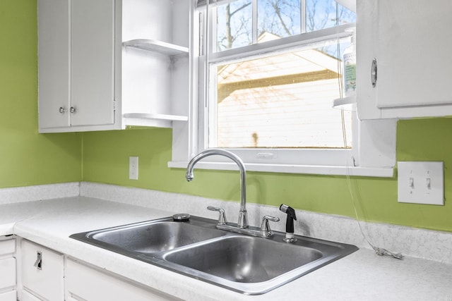 kitchen with white cabinetry and sink