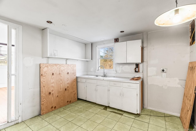 kitchen featuring sink and white cabinets