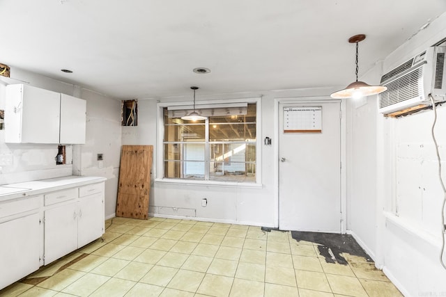 kitchen featuring pendant lighting, white cabinetry, and sink