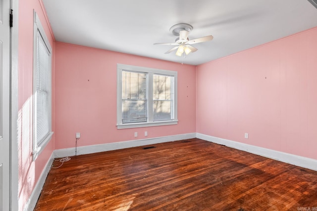 empty room with ceiling fan and dark wood-type flooring