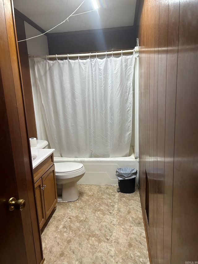 full bathroom with vanity, wood walls, toilet, and shower / bath combo with shower curtain