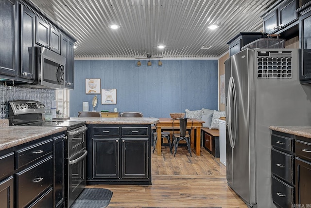 kitchen with light wood finished floors, light countertops, appliances with stainless steel finishes, wood ceiling, and dark cabinetry