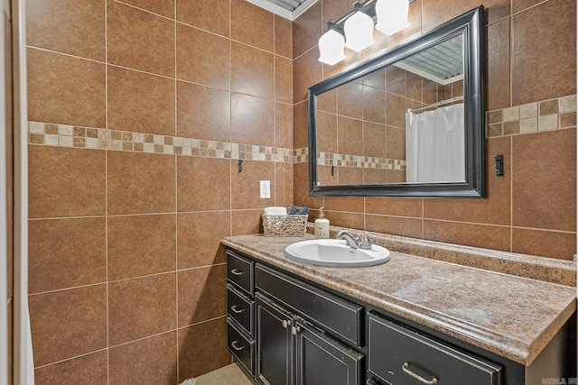 bathroom featuring tile walls, crown molding, and vanity