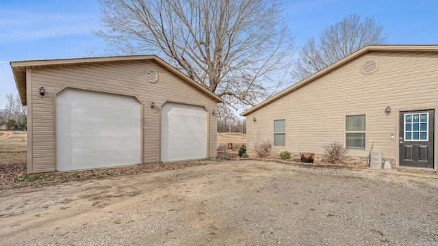 view of side of property with an outbuilding and a garage