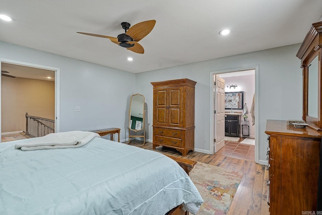 bedroom with light wood finished floors, ceiling fan, baseboards, and recessed lighting