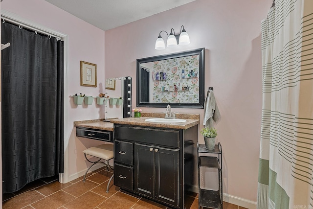 full bath featuring vanity, baseboards, and tile patterned floors